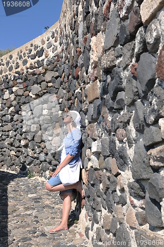 Image of Greek woman on the streets of Oia, Santorini, Greece