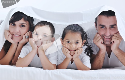Image of happy young Family in their bedroom
