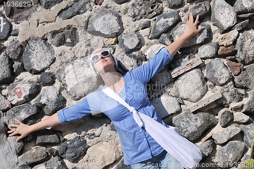 Image of Greek woman on the streets of Oia, Santorini, Greece