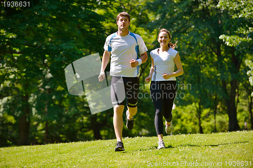 Image of Young couple jogging