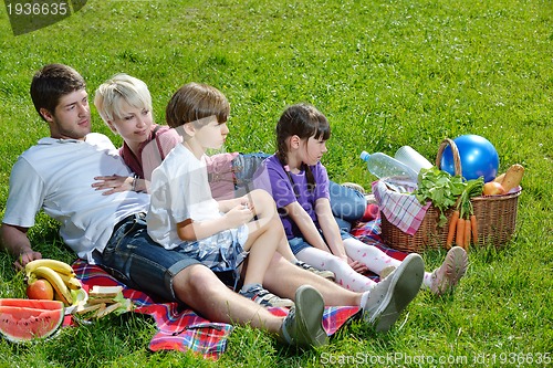 Image of Happy family playing together in a picnic outdoors