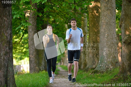 Image of Young couple jogging