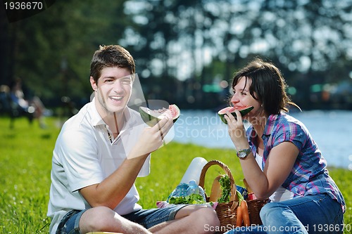 Image of happy young couple having a picnic outdoor