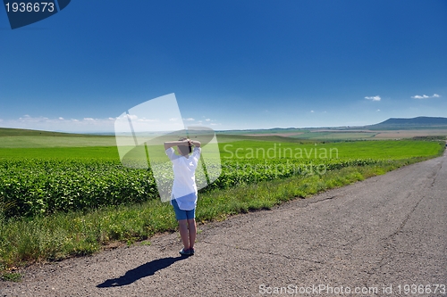 Image of Young happy woman in green field