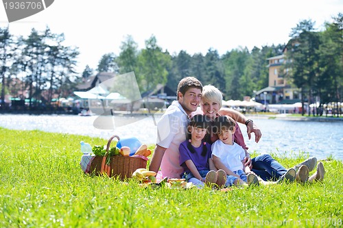 Image of Happy family playing together in a picnic outdoors