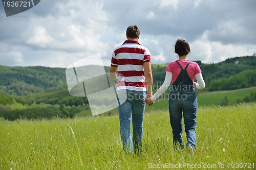 Image of Portrait of romantic young couple smiling together outdoor