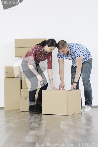 Image of Young couple moving in new home