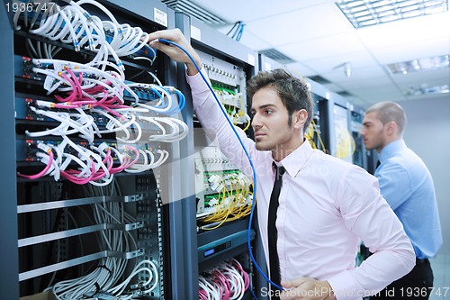 Image of it enineers in network server room