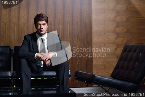 Image of happy young business man at office