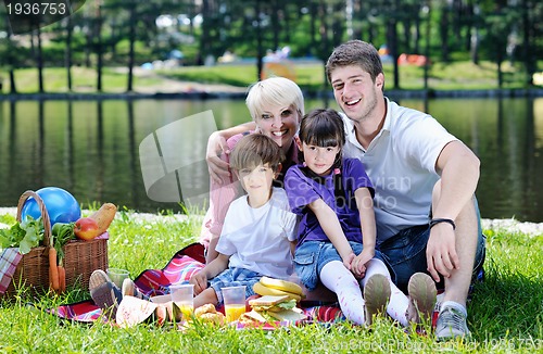 Image of Happy family playing together in a picnic outdoors