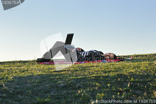 Image of young teen girl work on laptop outdoor