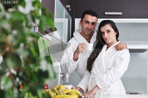 Image of Young love couple taking fresh morning cup of coffee