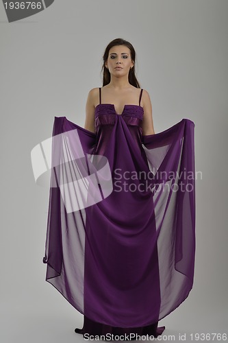 Image of elegant woman in fashionable dress posing in the studio