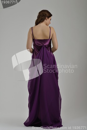 Image of elegant woman in fashionable dress posing in the studio