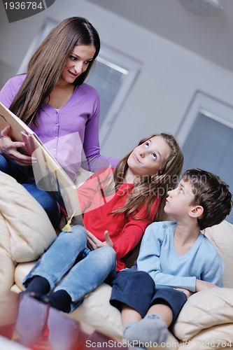 Image of young mom play with their kids at home and reading book