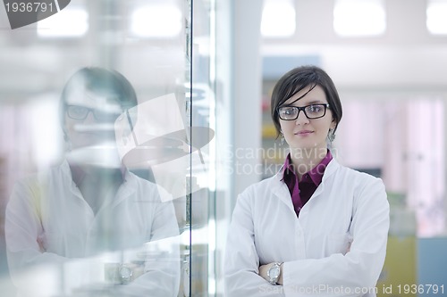 Image of pharmacist chemist woman standing in pharmacy drugstore