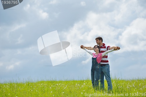 Image of Portrait of romantic young couple smiling together outdoor