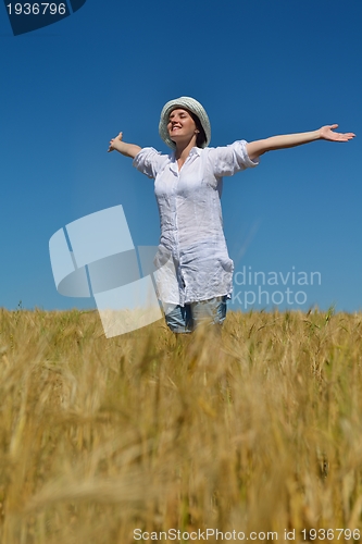 Image of young woman in wheat field at summer