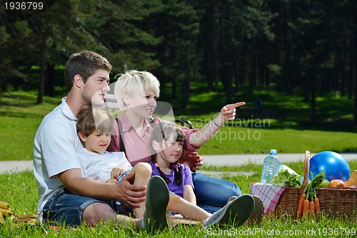 Image of Happy family playing together in a picnic outdoors