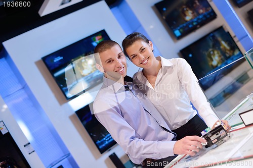 Image of Young couple in consumer electronics store