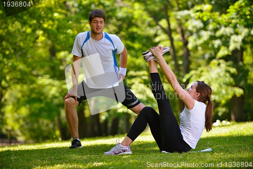Image of Couple doing stretching exercise  after jogging