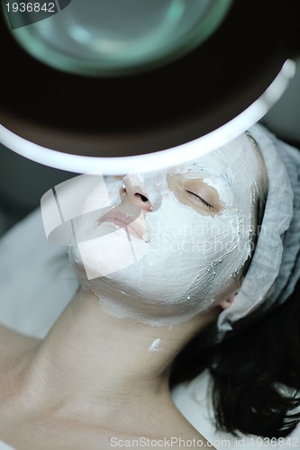 Image of woman with facial mask in cosmetic studio