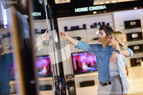 Image of Young couple in consumer electronics store