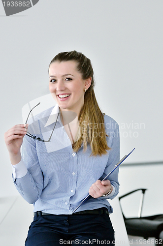 Image of business woman standing with her staff in background