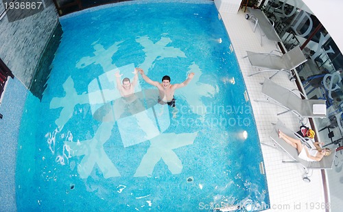 Image of young people group at spa swimming pool