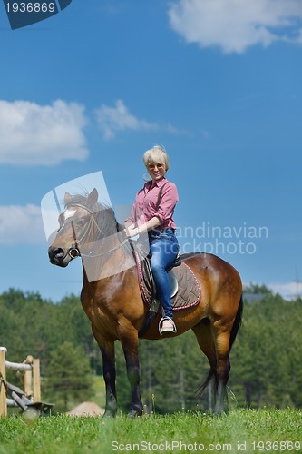 Image of happy woman  on  horse