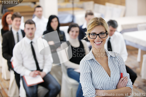 Image of business woman standing with her staff at conference