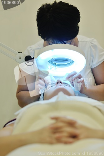 Image of woman with facial mask in cosmetic studio