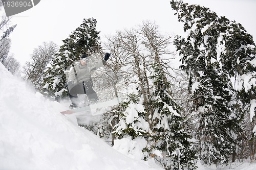 Image of snowboarder on fresh deep snow