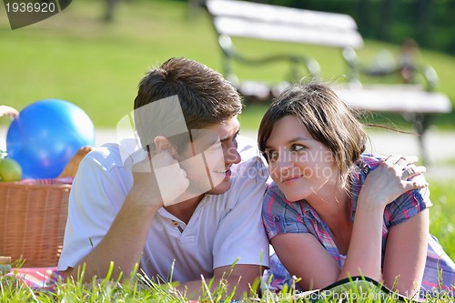 Image of happy young couple having a picnic outdoor
