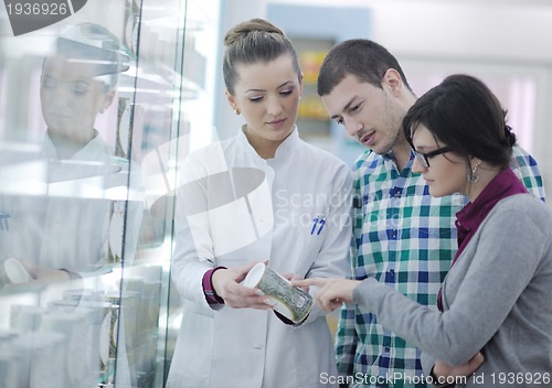 Image of pharmacist suggesting medical drug to buyer in pharmacy drugstor