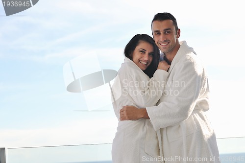 Image of couple relaxing on balcony