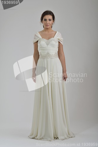 Image of elegant woman in fashionable dress posing in the studio