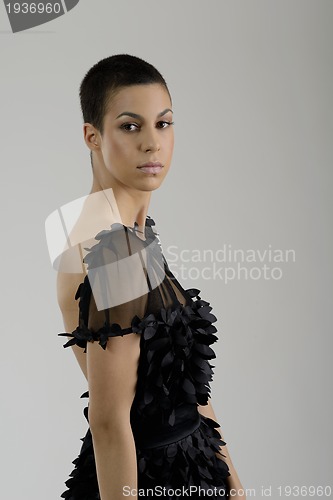 Image of elegant woman in fashionable dress posing in the studio