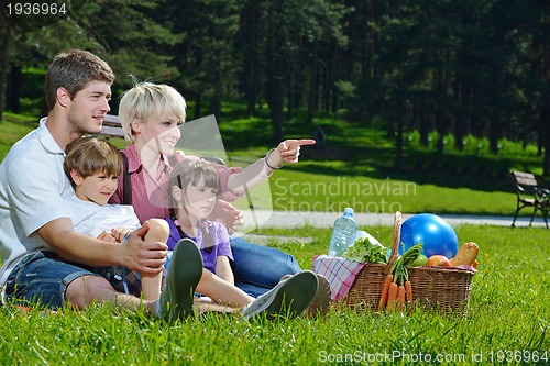 Image of Happy family playing together in a picnic outdoors