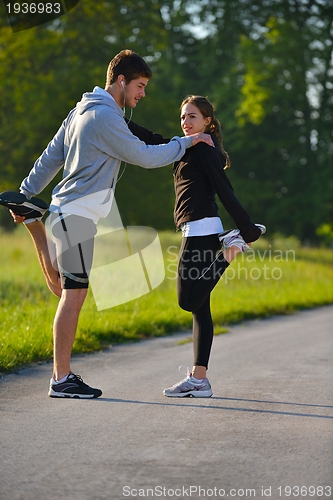 Image of Couple doing stretching exercise  after jogging