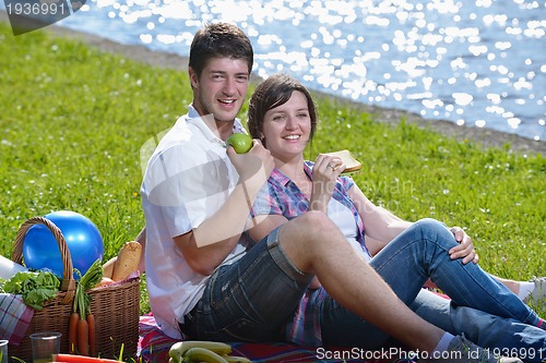 Image of happy young couple having a picnic outdoor