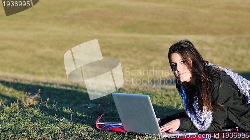 Image of young teen girl work on laptop outdoor