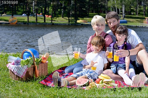 Image of Happy family playing together in a picnic outdoors