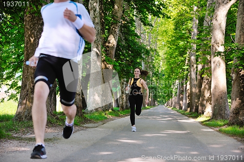 Image of Young couple jogging