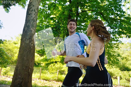 Image of Young couple jogging at morning