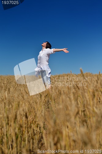 Image of young woman in wheat field at summer