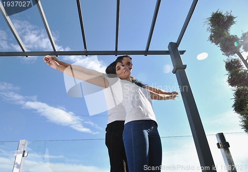 Image of couple relaxing on balcony