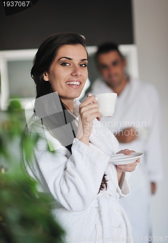 Image of Young love couple taking fresh morning cup of coffee