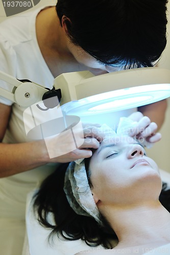 Image of woman with facial mask in cosmetic studio