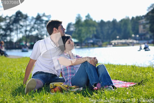 Image of happy young couple having a picnic outdoor